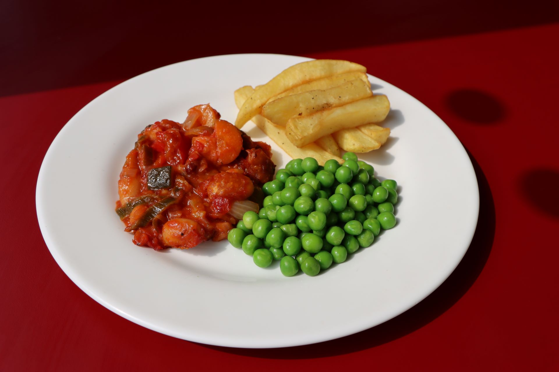 Cheesy Topped Vegetable and Bean Bake with Chips and Peas