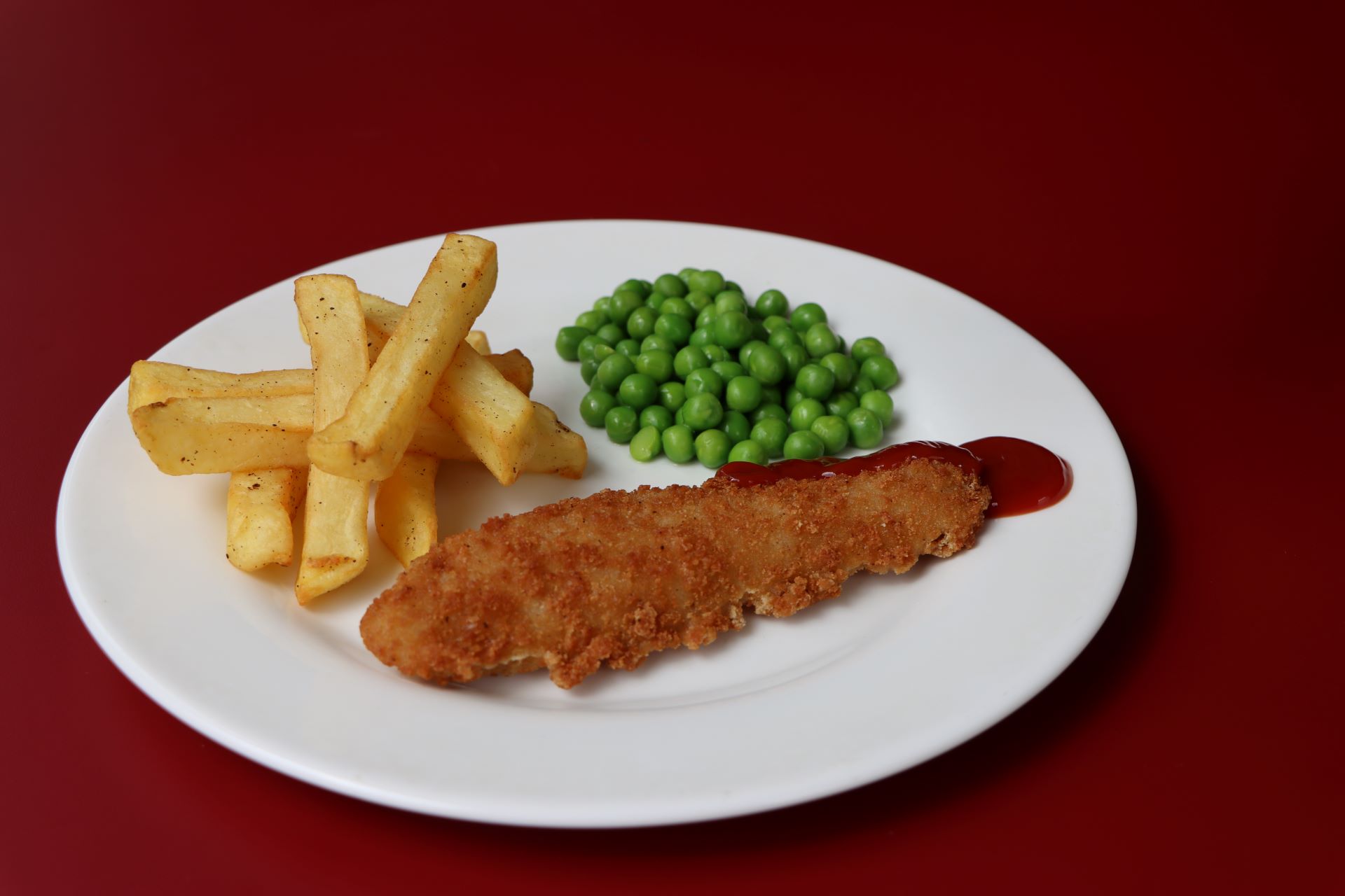 Breaded Fish with chips and Peas